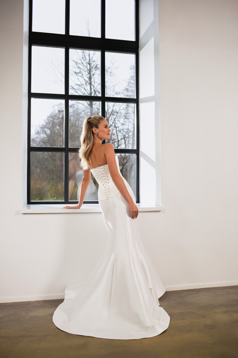 Full length back view of Priscilla off-white bridal set with long skirt vent and corset
