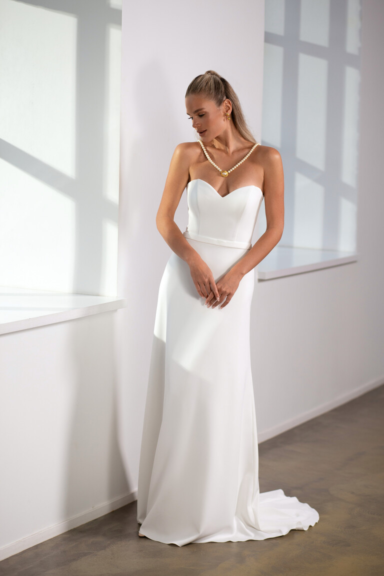 Adeline strapless crepe gown front view styled with pearls in natural light