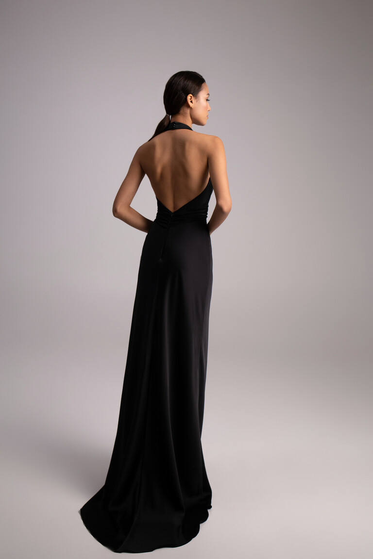 Full back view of Athena black slip dress featuring halter neck strap and deep open back