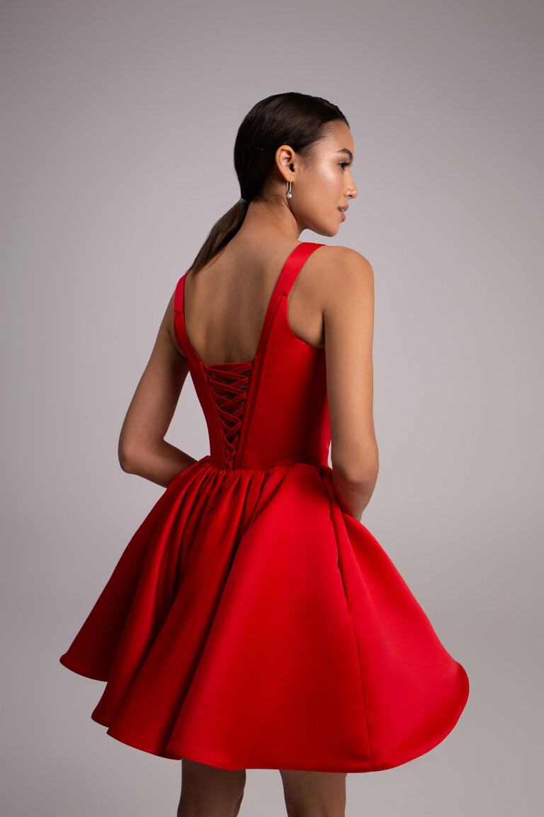 Back view of Casia red satin dress featuring lace-up corset and flared mini skirt