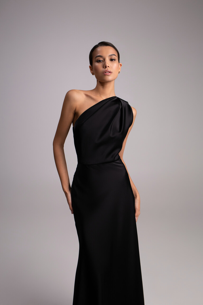 Julia black satin column dress front view showing asymmetrical neckline and sleek minimalist style