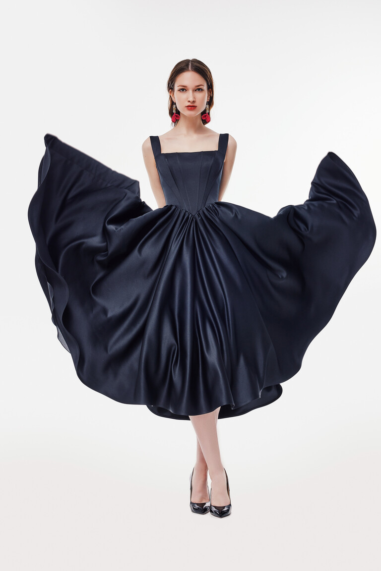 Casia Midi Dress A-Line Silhouette in Motion for Formal Events Casia black satin A-line midi dress in motion showing voluminous skirt and sleek square neckline