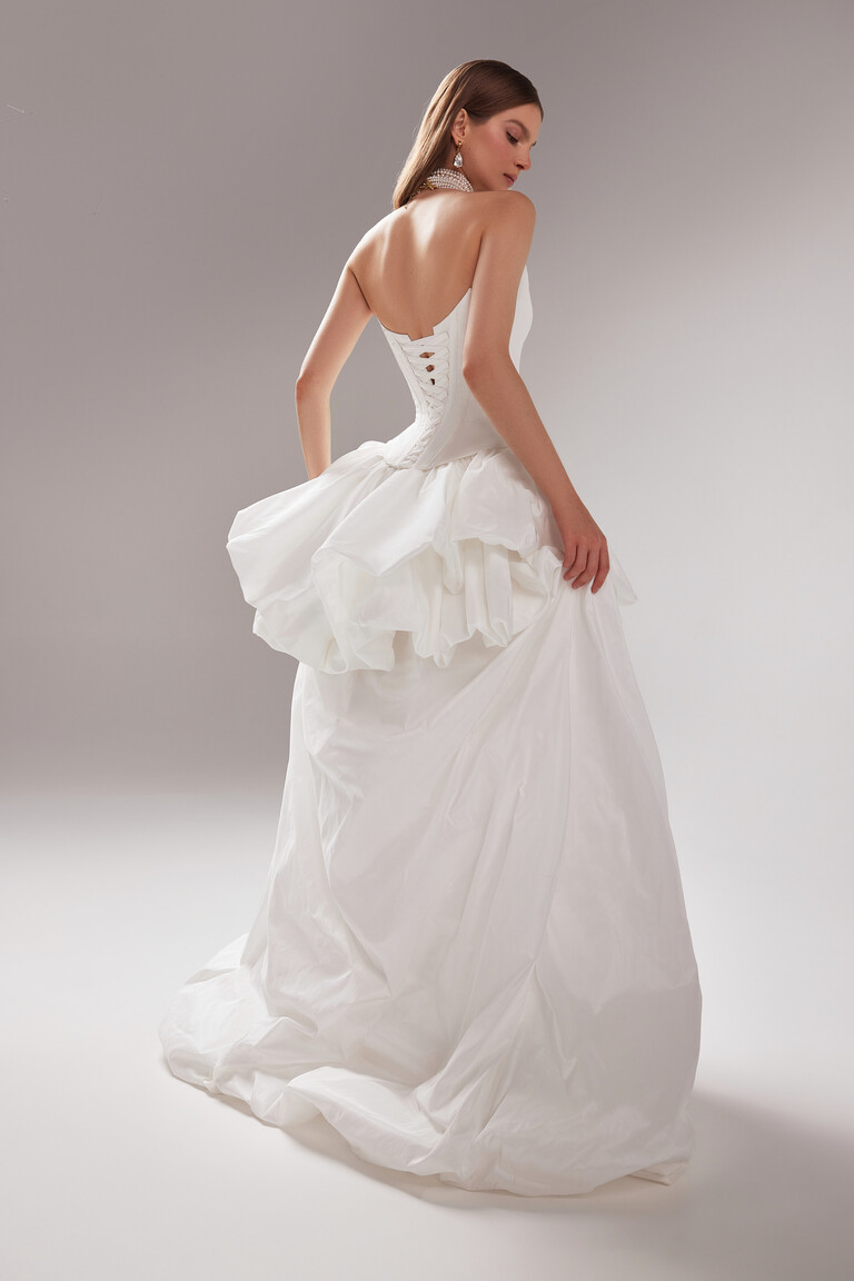 Full back view of the strapless Amber wedding dress in off-white, highlighting the lace-up corset and voluminous taffeta train.