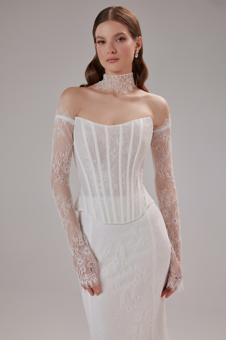 Unona Prima ivory wedding dress with a strapless corset, detachable lace sleeves, and matching choker, front view.