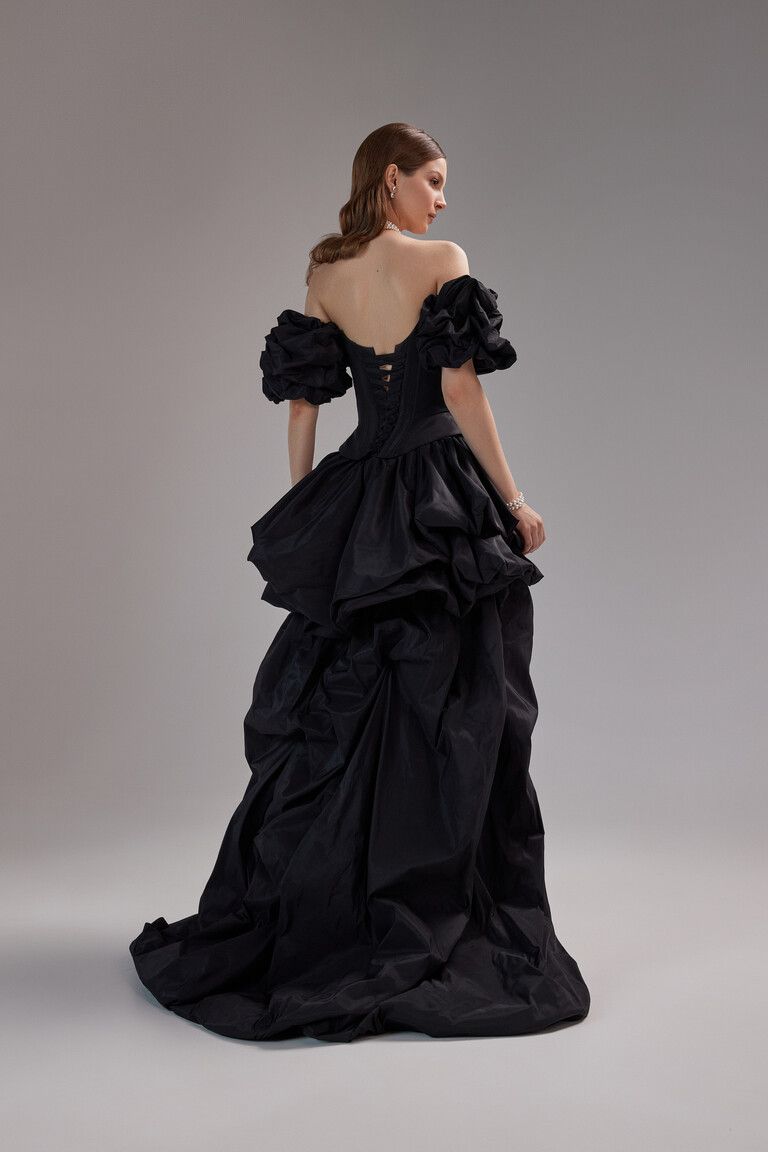 Full back view of the Unona Amber black occasion dress featuring the corset lacing detail and sculptural taffeta train