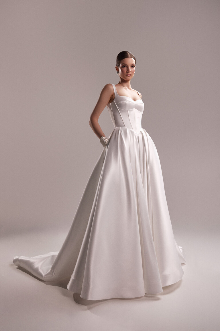Unona Antonia off-white mikado satin wedding gown showing the structured corset bodice with a sweetheart neckline and full floor-length skirt.