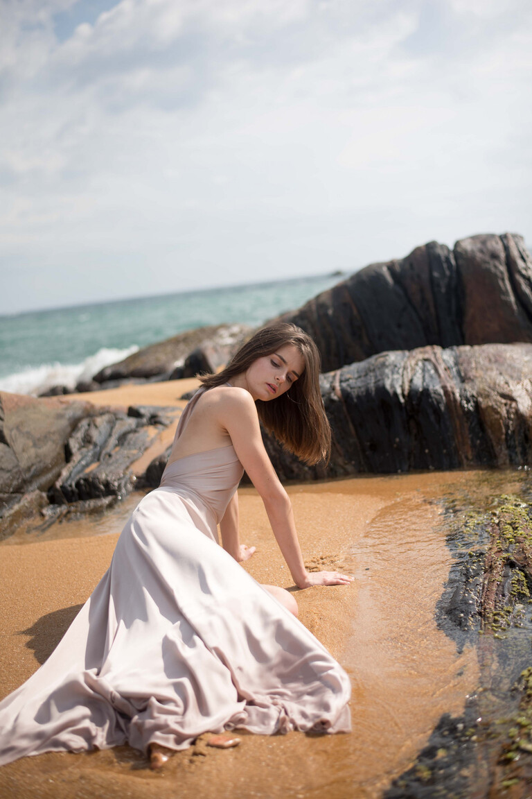 Unona Mary occasion dress in ash silk with a wrapped halter bodice creating a plunging neckline and flowing skirt.