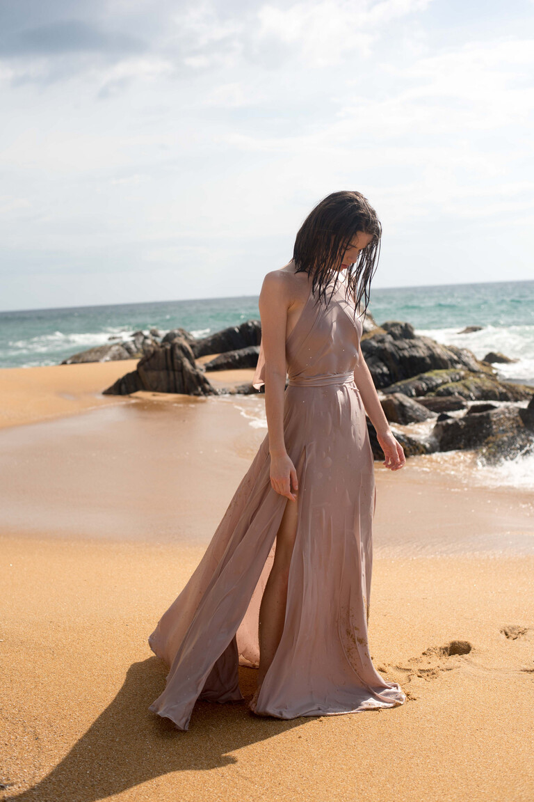 Full length view of the Unona Mary evening gown in ash silk showcasing its flowing floor-length A-line skirt and high slit.
