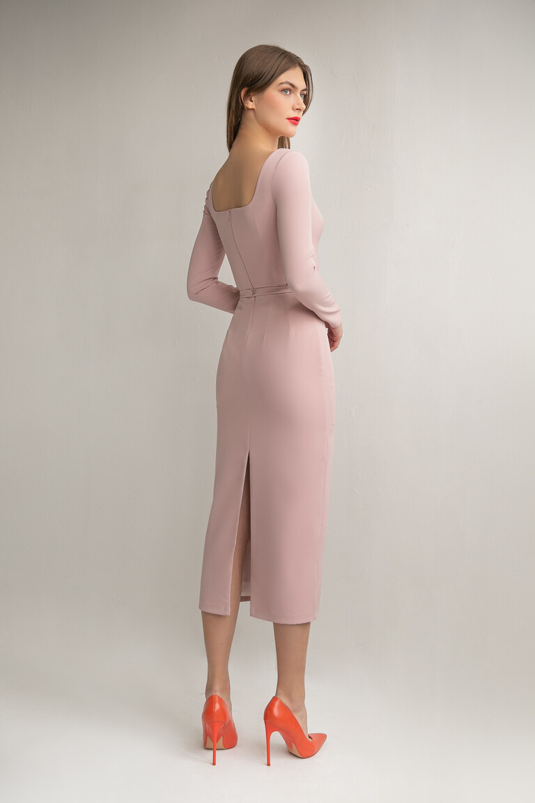 Three-quarter back view of the Viola powder dress by Unona highlighting the sheath silhouette and center back skirt slit