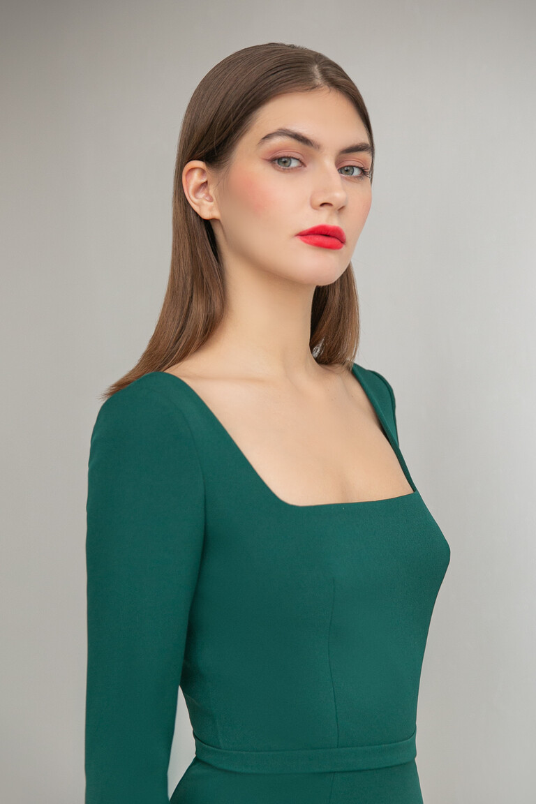 Close-up of the Unona Viola green dress bodice highlighting the structured square neckline and fitted princess seams