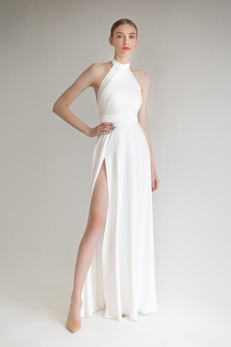 Front view of the Unona Mary sleeveless ivory silk wedding gown with a high halter neckline and A-line skirt