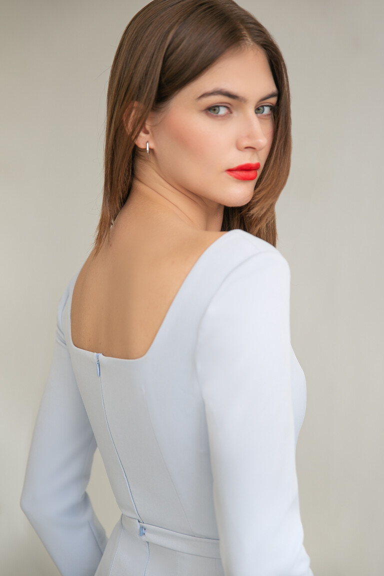 Three-quarters back view of the Unona Viola blue dress showing the elegant square back neckline and zipper.