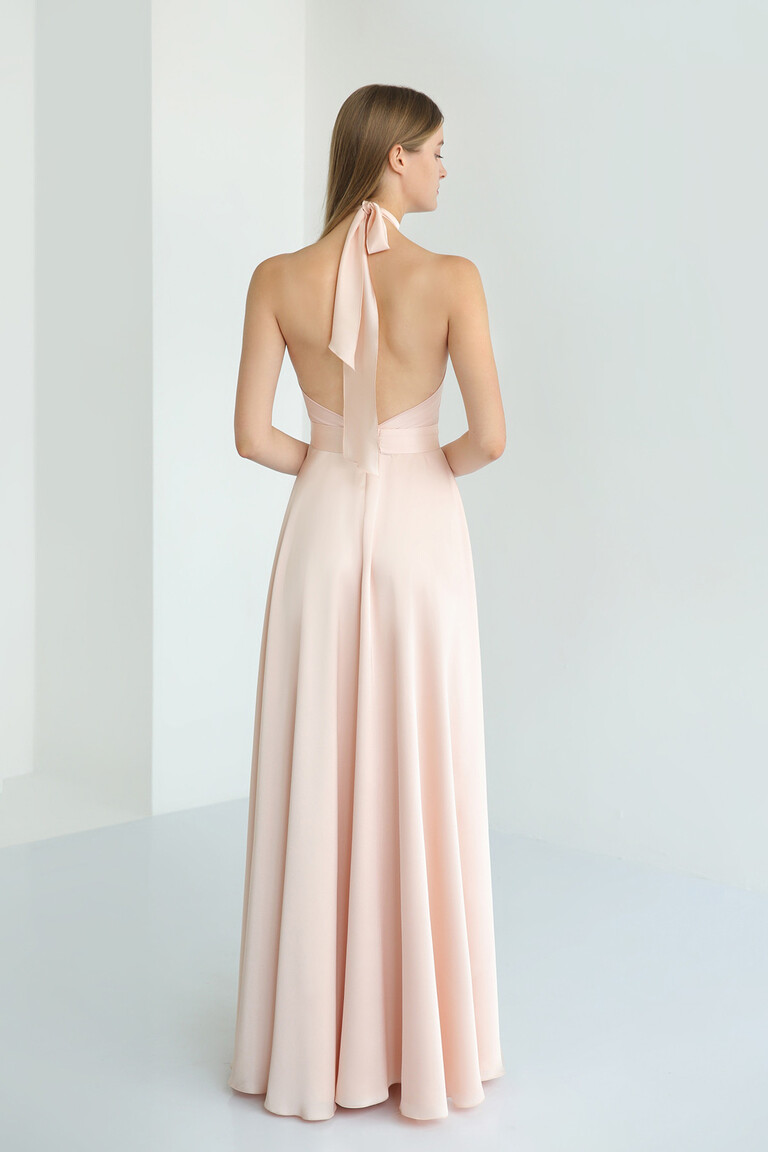 Back view of the Unona Mary peach silk dress showcasing its stunning low open back and long halter neck ties.