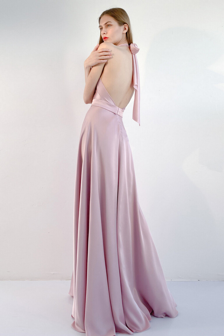 Unona Mary silk gown in powder pink, back view showcasing the stunning open back with elegant halter neck ties and a flowing skirt.