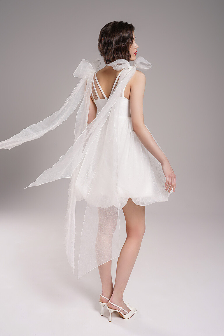 Side and back view of Leoni ivory engagement dress by Unona. Highlights removable shoulder bows with flowing tulle ribbons.