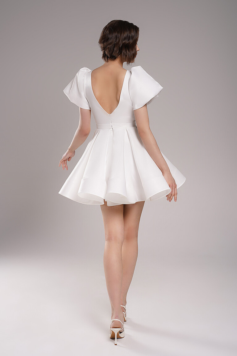 Back view of Unona Audrey mini ivory wedding dress highlighting the elegant V-back and puffy sleeves in lurex satin.