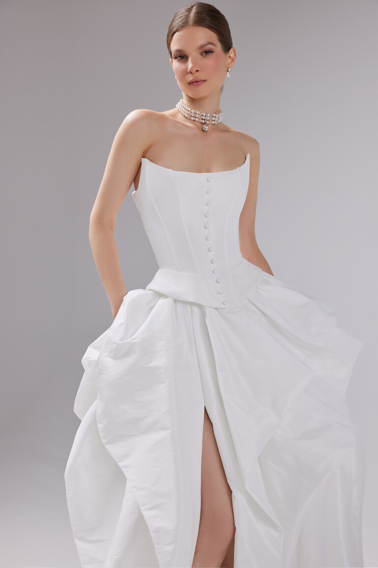 Unona Sonara off-white taffeta wedding dress featuring a strapless corset bodice and covered buttons.