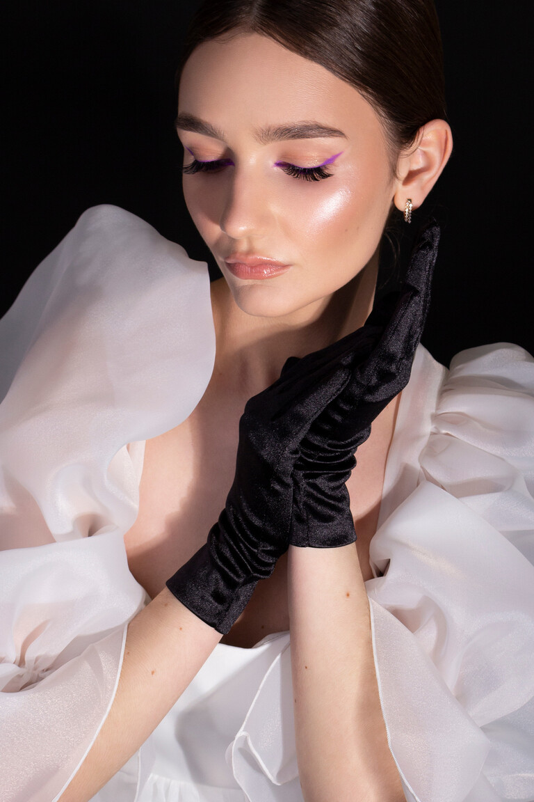 Close up detail of Lessi short wedding dress by Unona. Showcases the delicate sheer glitter tulle puff sleeves and styling.