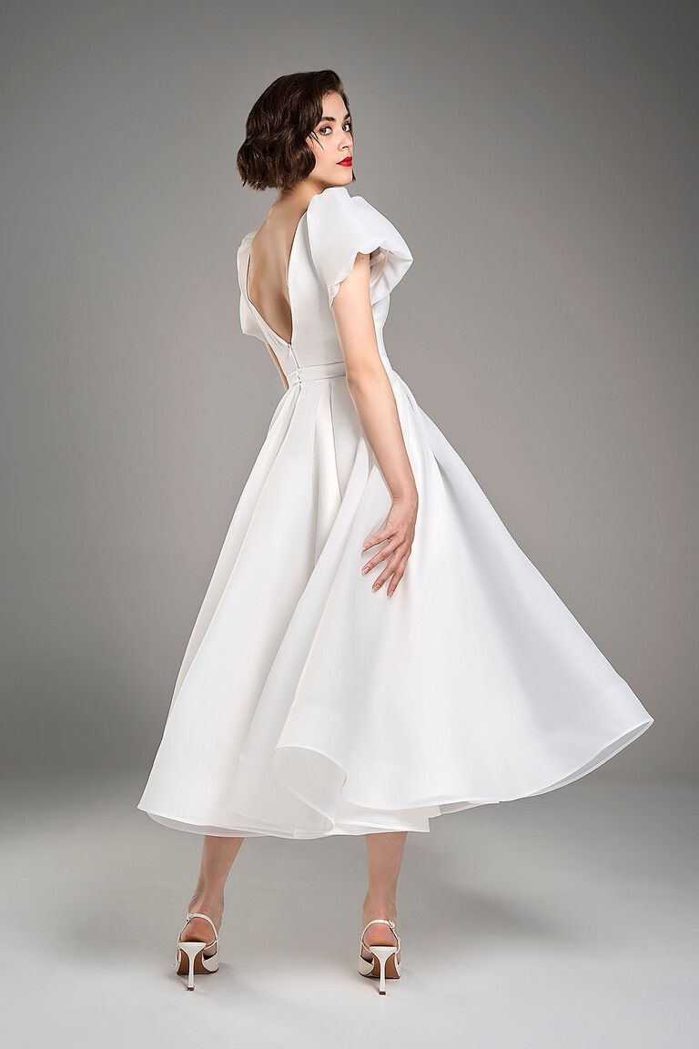 Back view of Audrey midi ivory wedding dress revealing an elegant open V-shaped backline and flared skirt