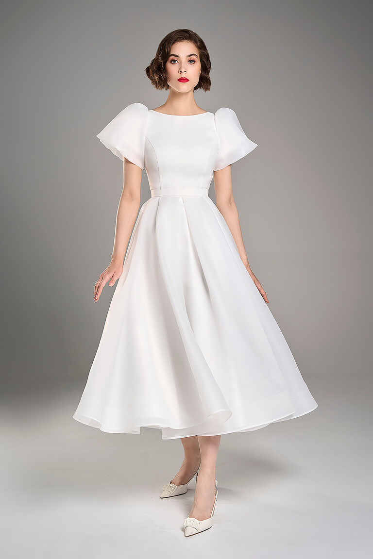 Elegant Audrey midi ivory wedding gown featuring a translucent organza overlay and romantic puff sleeves