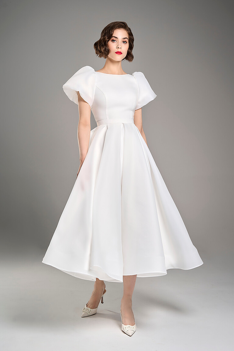 Full frontal view of Audrey midi ivory bridal dress with a high neckline and pleated A-line organza skirt