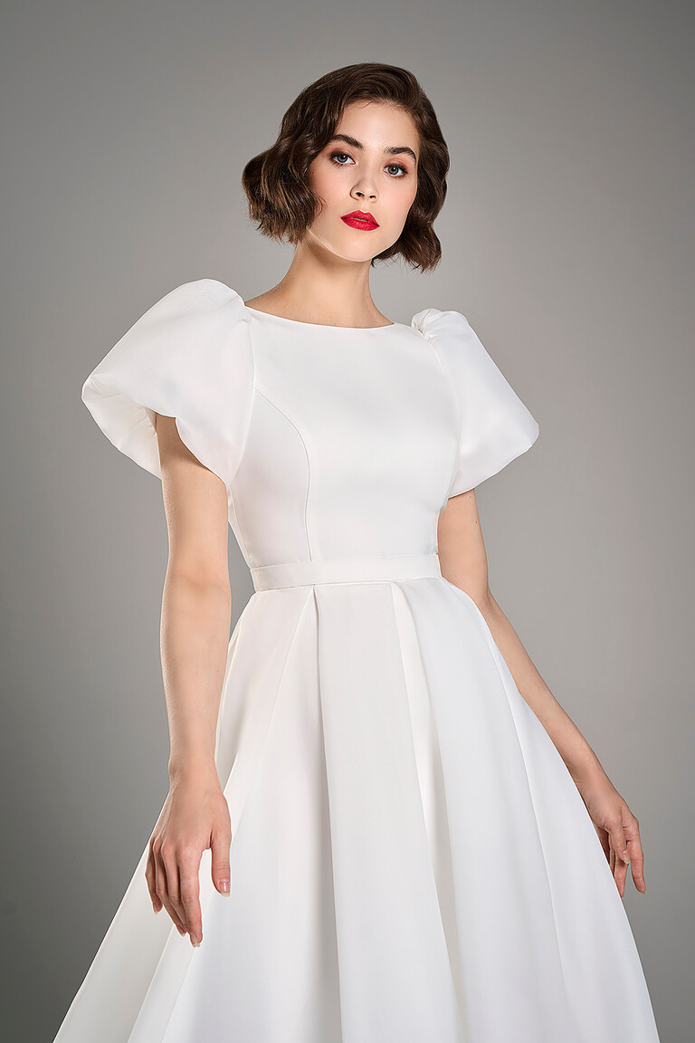 Bodice details of the Audrey midi ivory wedding dress showing princess seams and delicate puff sleeves
