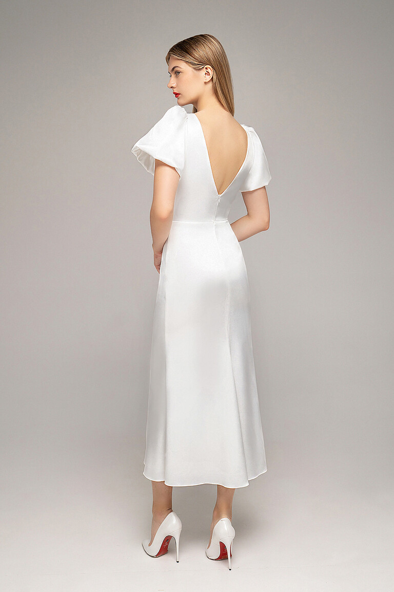 Back three-quarter view of Unona Audrey-1 midi ivory bridal dress. Showcases the elegant open backline.