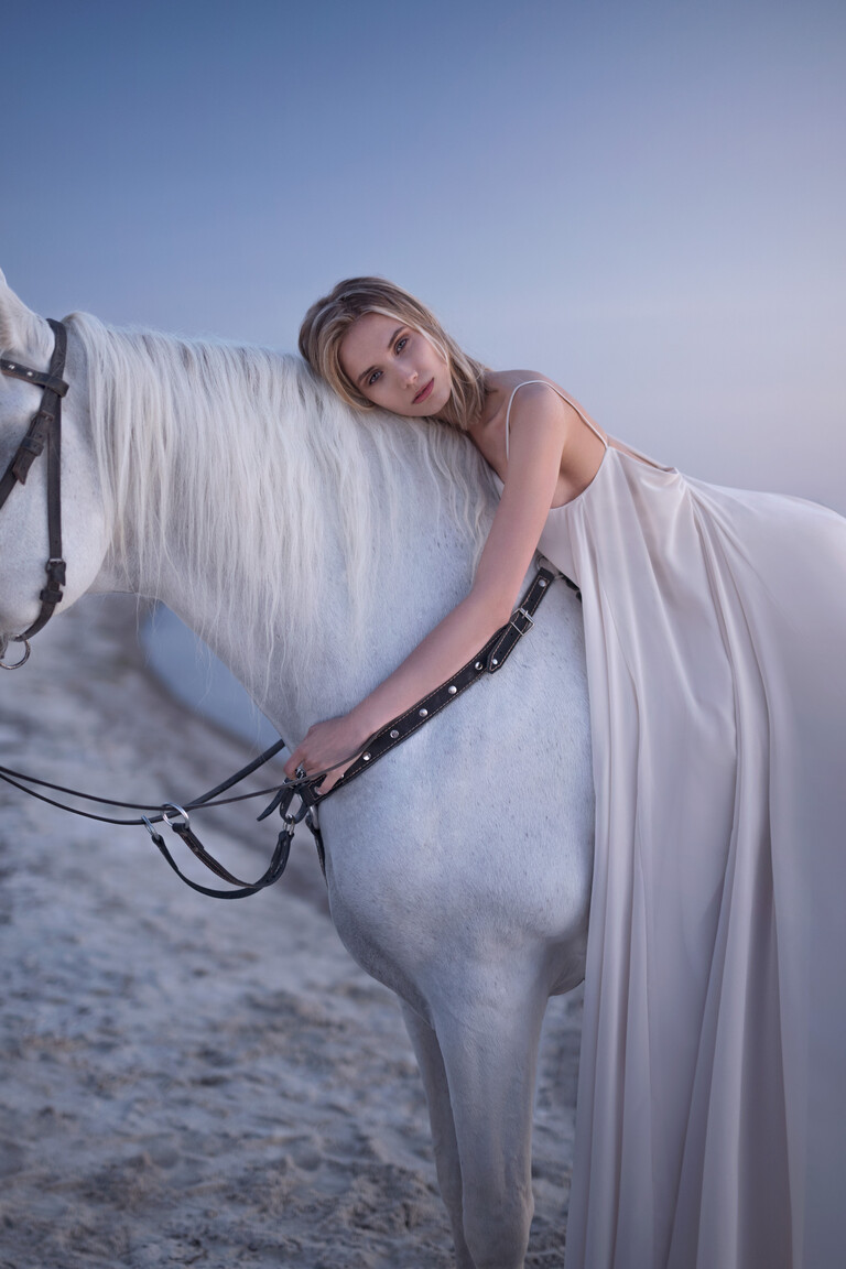 Side view of the sleeveless Unona Isa bridal gown in ash, showcasing the floor-length flowing three-layered chiffon skirt.