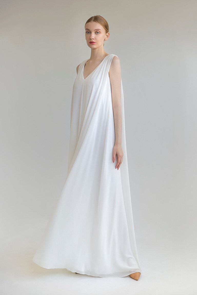 Unona Joan wedding dress in ivory shown from the front. A sleeveless A-line chiffon gown with a V-neck and flowing silhouette.