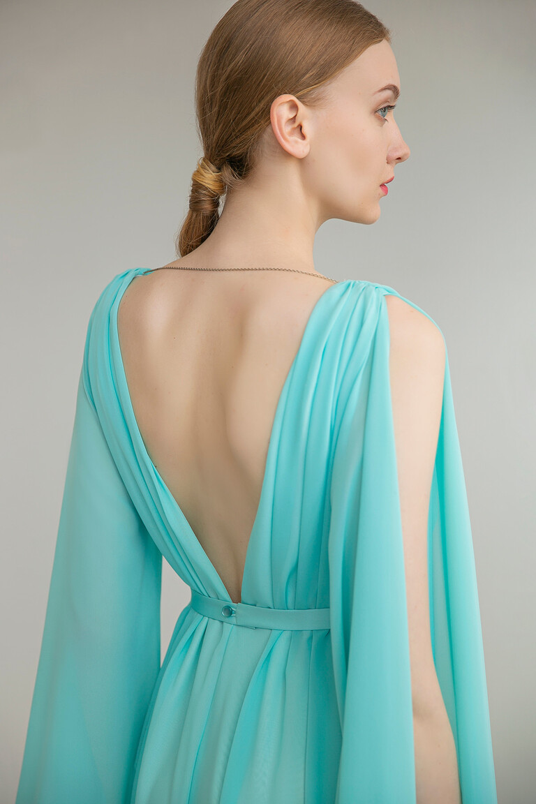 Exquisite Details of the Joan Evening Dress Close-up of the Unona Joan gown back details featuring the V-open back thin belt and delicate chain accent