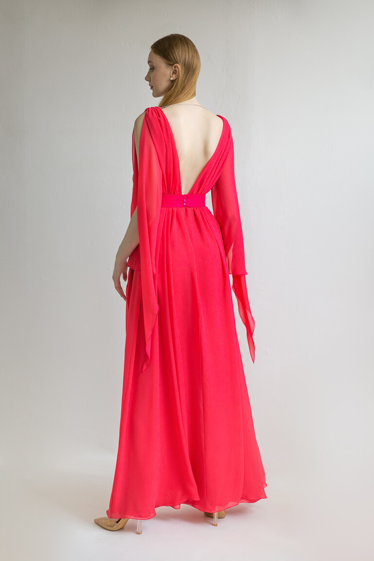 Full back view of the Unona Joan red chiffon dress with its V-cut open back, cape sleeves, and wide matching belt.