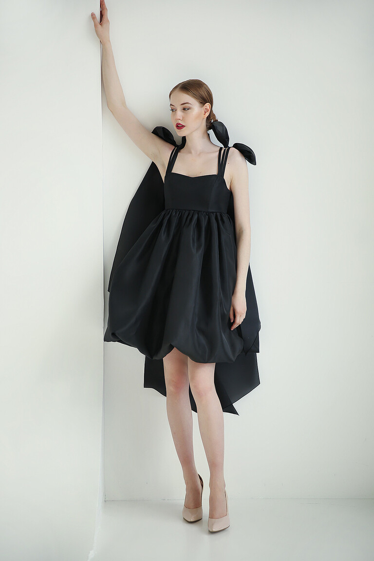 Leoni short black evening dress with dramatic sheer organza shoulder bows creating an elegant cascading effect.