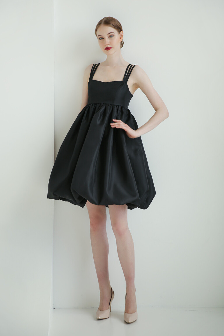 Minimalist styling of the Leoni short black organza A-line dress featuring a high waistline and structured balloon skirt.