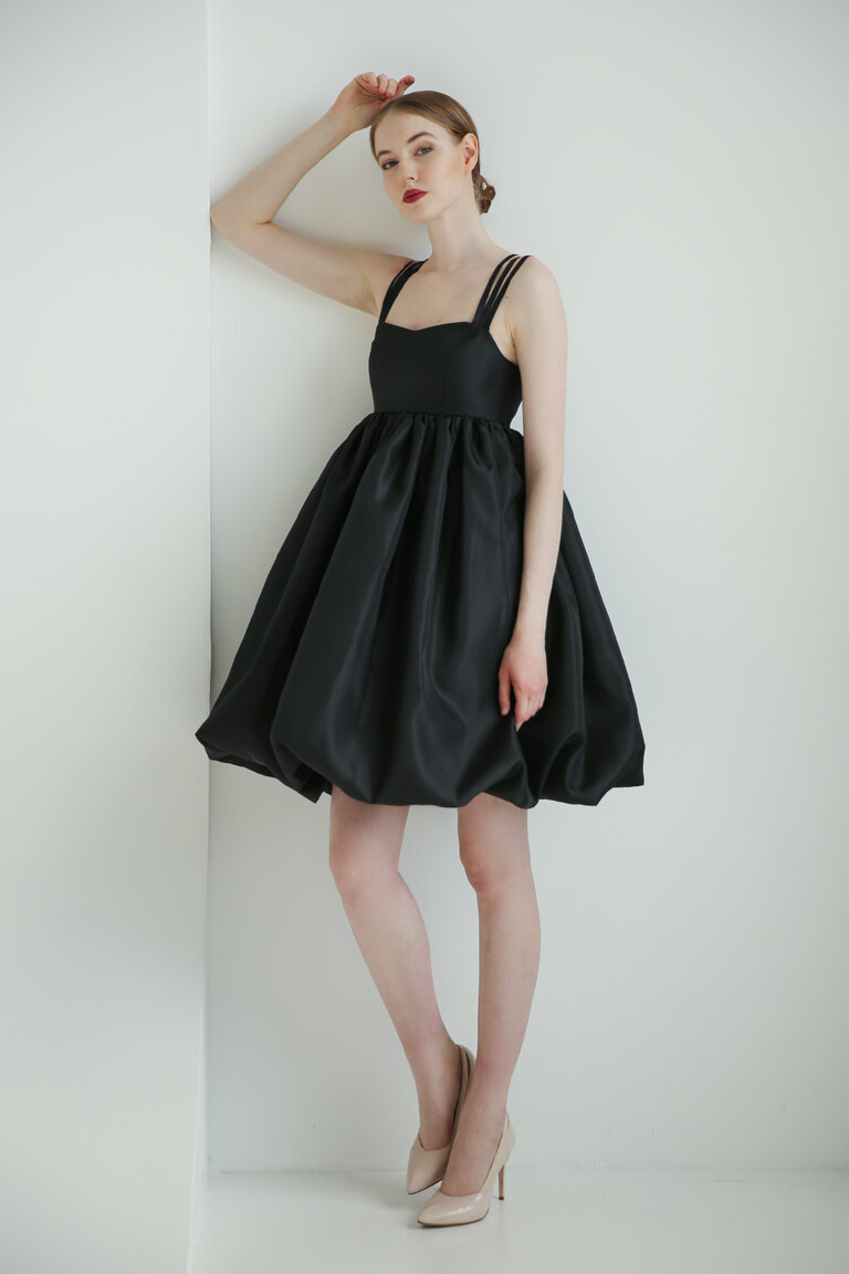 Unona Leoni sleeveless black cocktail dress with a modern square neckline and playful organza babydoll skirt.