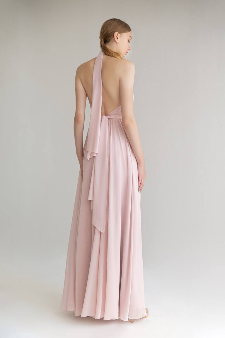 Back view of the Unona Calypso powder chiffon gown featuring the dramatic open back and halter neck tie with a long sash