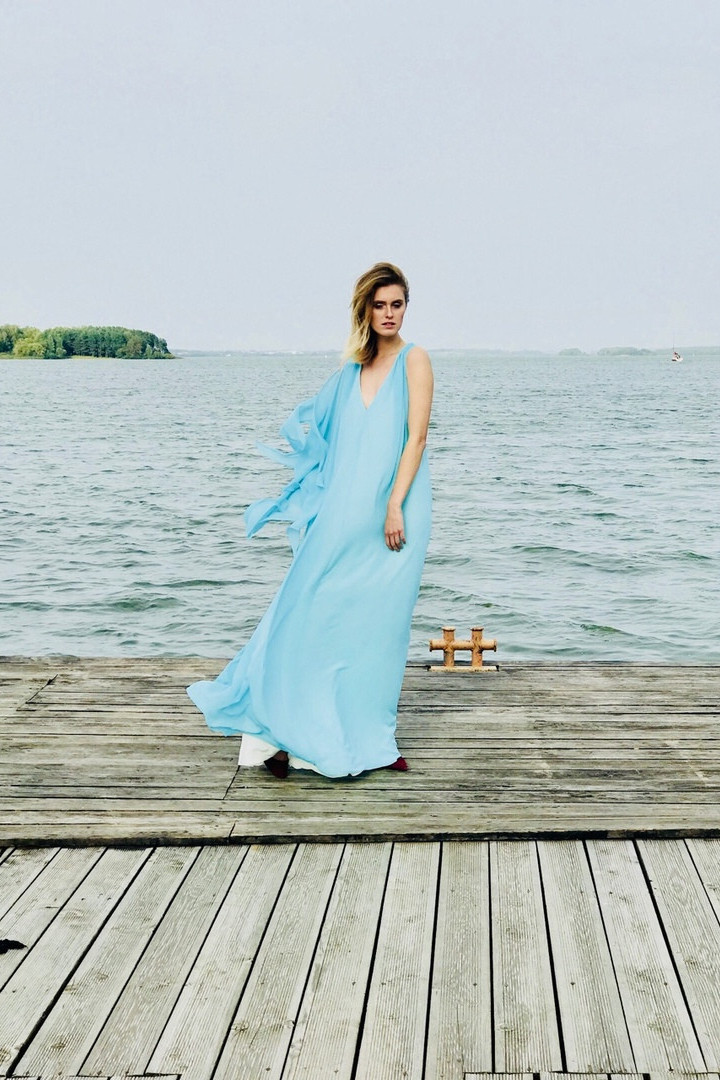 Joan Dress: Perfect for Your Special Occasion Model wearing the Unona Joan A-line chiffon dress in Tiffany Blue full front view on a pier by the water