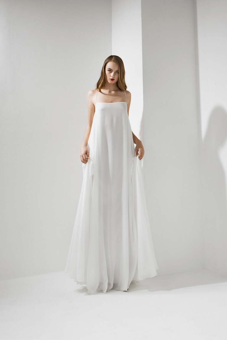 Unona Isa ivory chiffon gown front view. A loose, sleeveless A-line dress perfect for a modern minimalist bridal look.