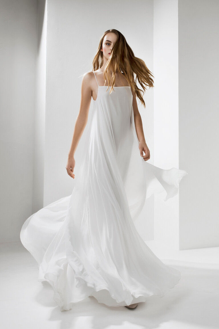 Unona Isa sleeveless wedding dress in motion. The ivory chiffon A-line skirt creates a beautiful voluminous and flowing effect.