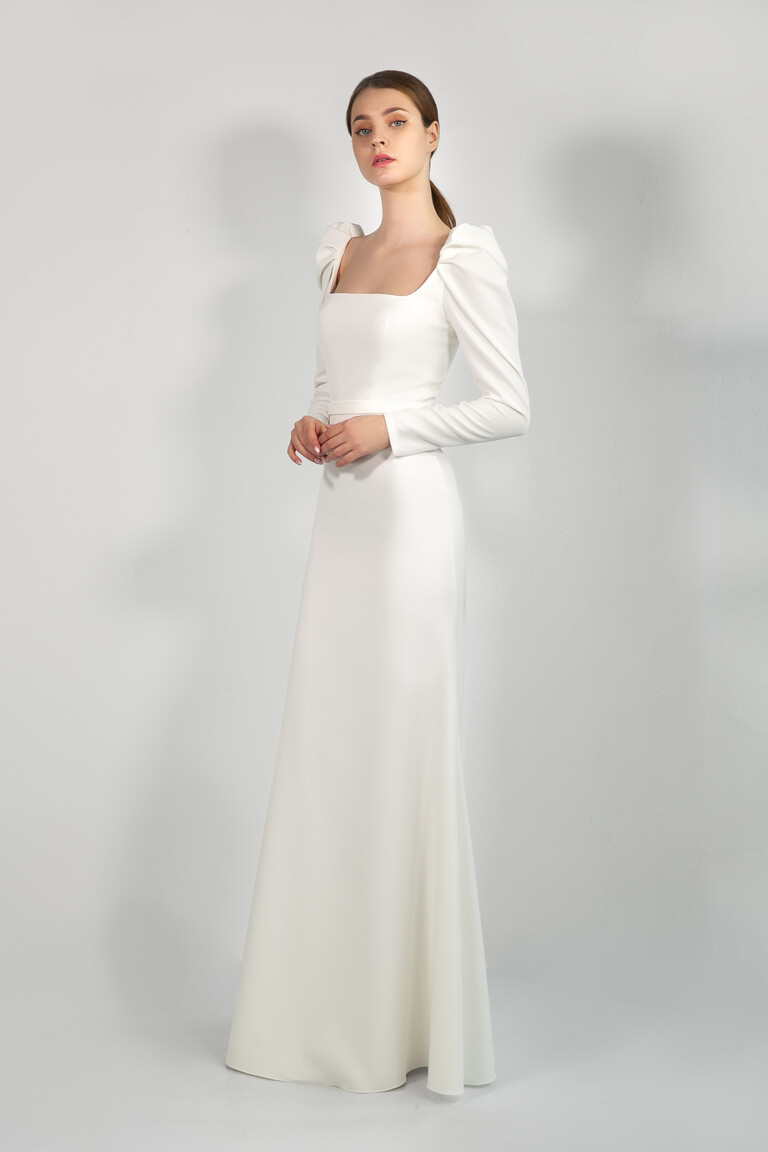 Bianca Ivory Stretch Crepe Gown 3/4 View Three quarter view of Bianca ivory sheath wedding dress by Unona featuring vintage inspired long sleeves.