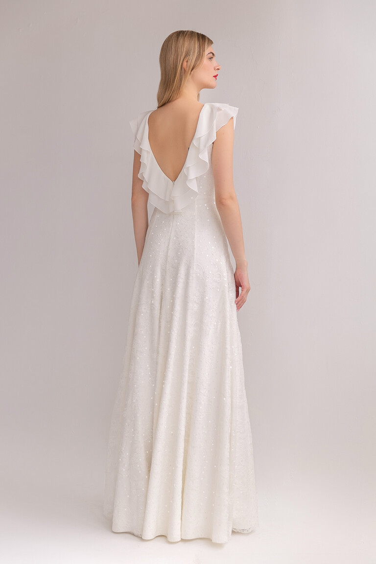 Rear angled view of the Alison ivory lace gown highlighting the low V-back, bohemian charm, and hidden back zipper.