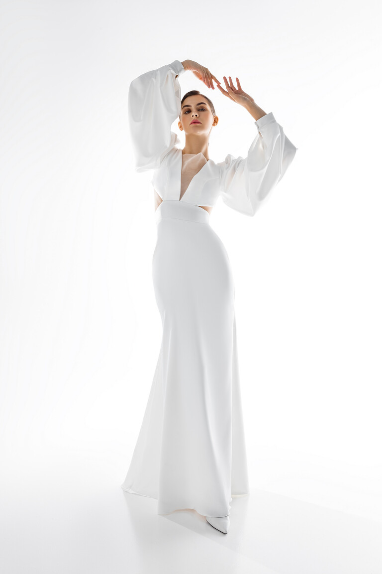 Hannah Minimalist Fitted Bridal Gown with Long Sleeves Hannah minimalist ivory stretch satin wedding dress showing floor-length fitted silhouette and long voluminous sleeves.