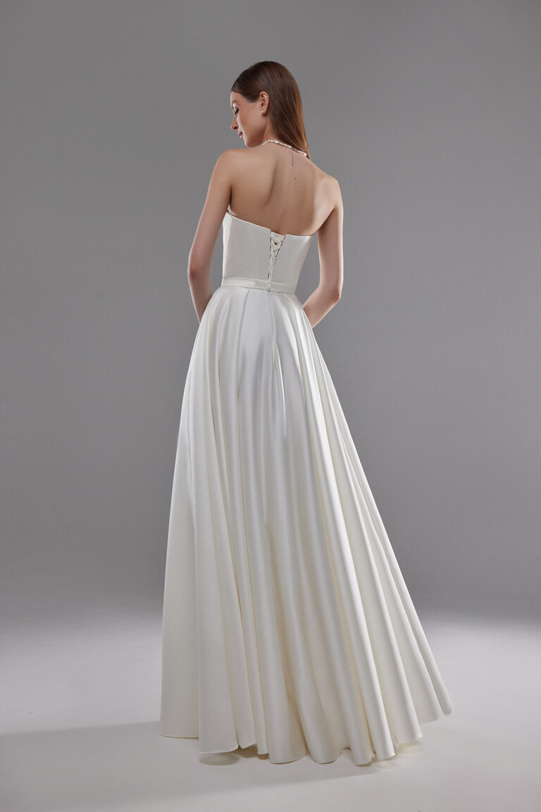 Elegant Lace-Up Corset Back of Lizzie Gown Back view of Lizzie ivory satin bridal gown featuring an elegant lace-up corset back and sweeping A-line skirt.