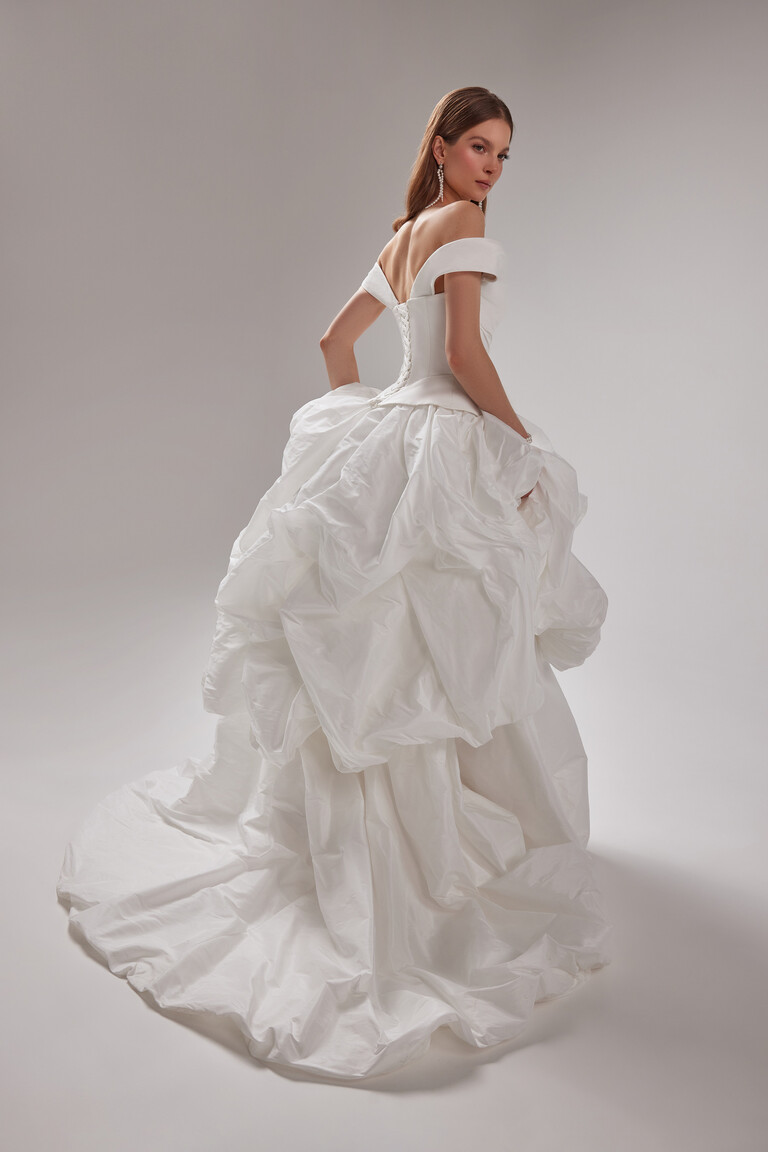 Paradise Ruffled Taffeta Wedding Dress with Sweeping Train and Lace-Up Back Unona Paradise off-white taffeta bridal gown back view. Lace-up corset bodice, ruffled skirt and a sweeping train.