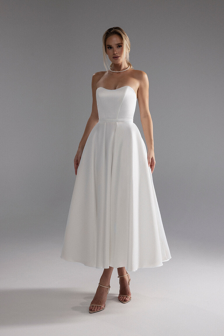 Lizzie ivory satin A-line midi wedding dress showing a structured strapless sweetheart bodice.