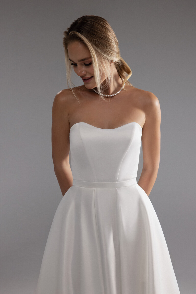 Lizzie ivory satin strapless wedding dress highlighting the classic sweetheart neckline and waist.