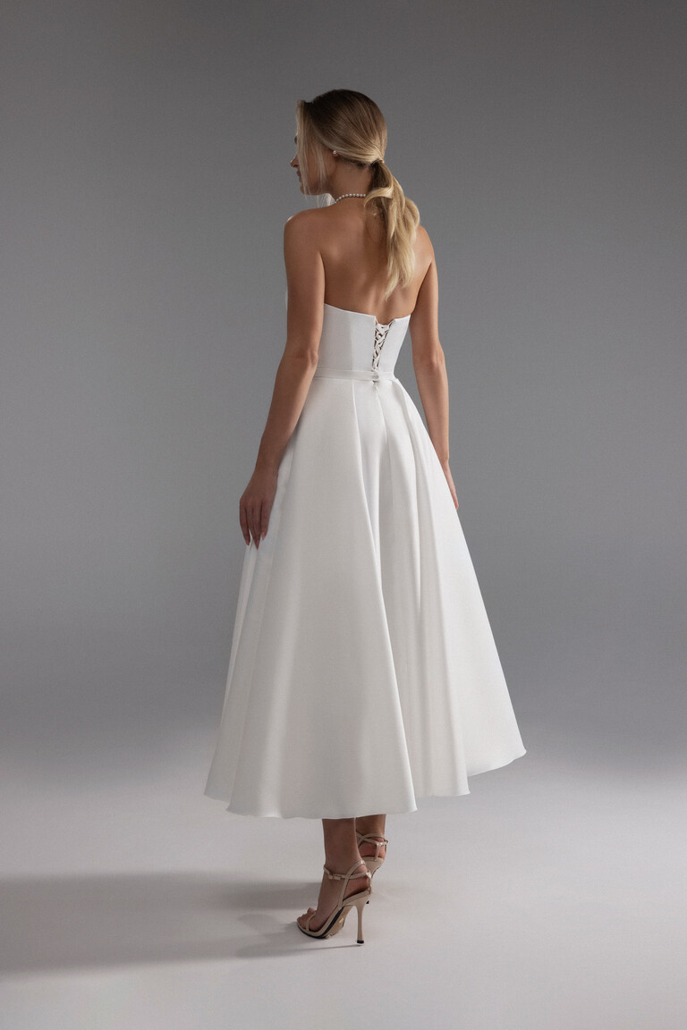 Back view of Lizzie ivory strapless midi wedding dress with an adjustable lace-up corset closure.
