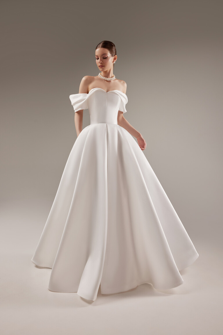 Elegant Fly A-Line Wedding Dress Off-white Fly A-line wedding dress by Unona featuring a minimalist Mikado skirt and elegant off-the-shoulder bodice.
