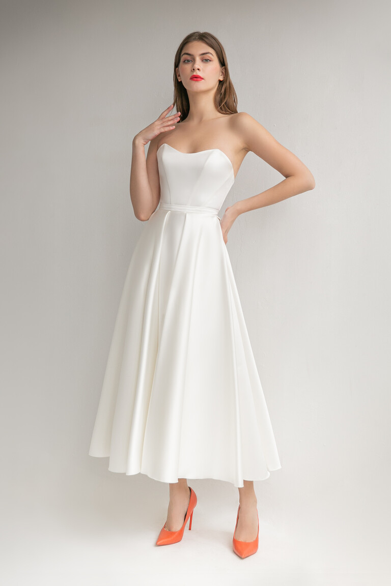 Lizzie modern minimalist ivory midi wedding dress featuring an A-line skirt and strapless bodice.