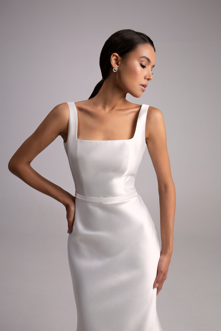Mika Dress Bodice and Square Neckline Details Close up of Mika minimalist wedding dress bodice. Shows square neckline, wide straps, and luxurious ivory mikado fabric.