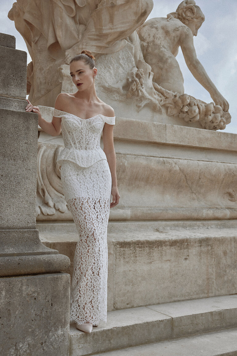 Front view of Unona Pippa off-white lace bridal separates with off-the-shoulder corset and peplum waist.